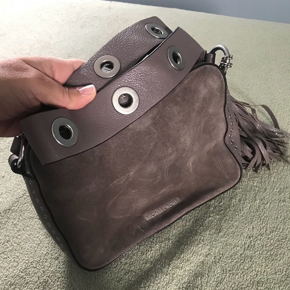 Suede MK crossbody with thick grommet strap.